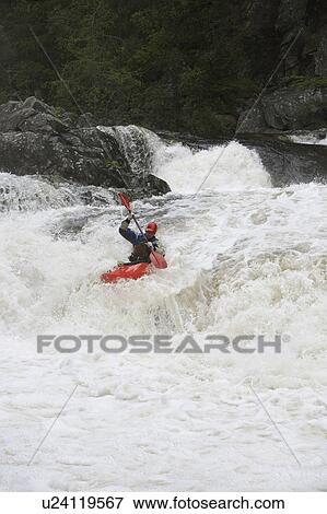 Stock Photo - Man kayaking in river. Fotosearch
