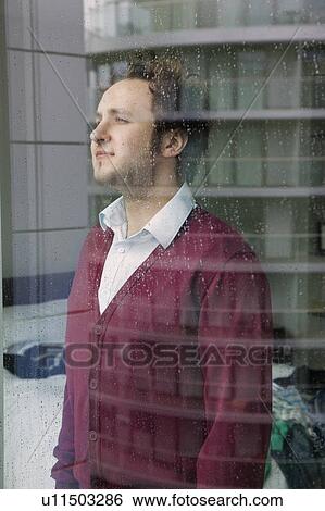 Man looking through window View Large Photo Image Stock Photograph - Man looking through window. Fotosearch
