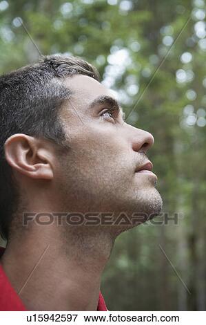Man looking up, outdoors View Large Photo Image Stock Photo - Man looking up, outdoors. Fotosearch