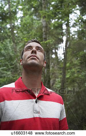 Man looking up, outdoors View Large Photo Image Stock Photo - Man looking up, outdoors. Fotosearch