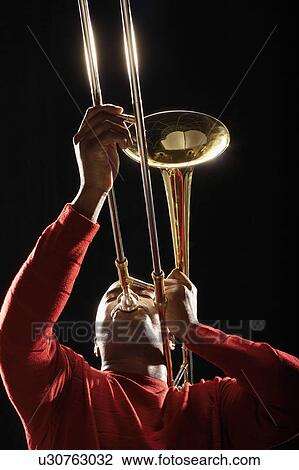 Man Playing Trombone, low angle view View Large Photo Image Stock Image - Man Playing Trombone, low angle view. Fotosearch