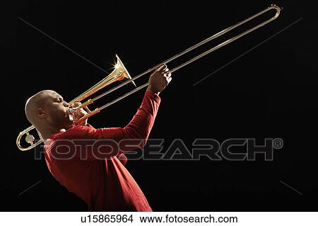Picture - Man Playing Trombone, side view. Fotosearch