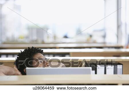 Man relaxing behind office desk View Large Photo Image Stock Photo - Man relaxing behind office desk. Fotosearch