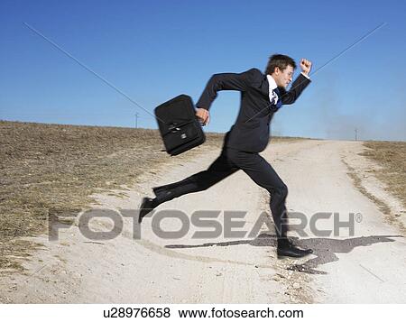 Man running across road View Large Photo Image Stock Photo - Man running across road. Fotosearch