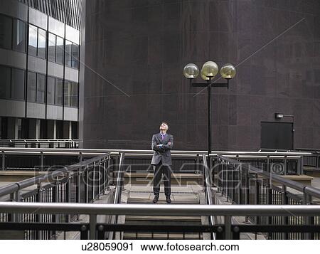Man standing at top of steps, looking up View Large Photo Image Stock Image - Man standing at top of steps, looking up. Fotosearch