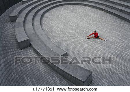 Man stretching in the Scoop amphitheatre, London, England, elevated view View Large Photo Image Stock Image - Man stretching in the Scoop amphitheatre, London, England, elevated view. Fotosearch