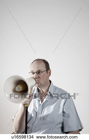 Man talking through megaphone View Large Photo Image Picture - Man talking through megaphone. Fotosearch
