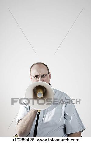Stock Photograph - Man talking through megaphone. Fotosearch