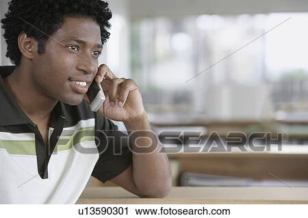 Man using mobile phone in office View Large Photo Image Stock Image - Man using mobile phone in office. Fotosearch