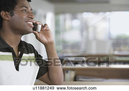 Man using mobile phone in office View Large Photo Image Stock Photo - Man using mobile phone in office. Fotosearch