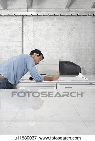 Mid adult man drawing on sheet of paper, side view View Large Photo Image Stock Photo - Mid adult man drawing on sheet of paper, side view. Fotosearch