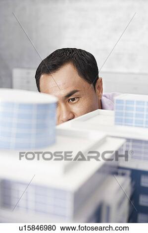 Mid adult man looking at architectural model, close-up View Large Photo Image Stock Image - Mid adult man looking at architectural model, close-up. Fotosearch