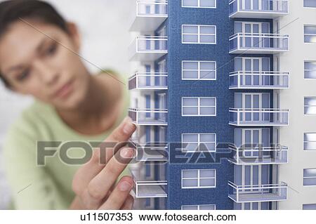 Mid adult woman inspecting architectural model, close-up View Large Photo Image Stock Image - Mid adult woman inspecting architectural model, close-up. Fotosearch