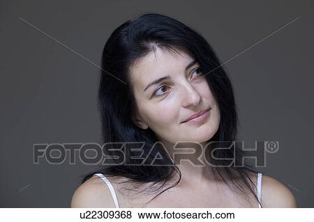 Mid-adult woman looking away, close-up view, studio shot View Large Photo Image Stock Photo - Mid-adult woman looking away, close-up view, studio shot. Fotosearch