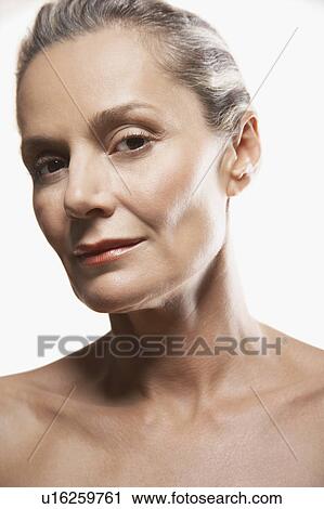Stock Image - Middle-Aged Woman, head tilted to side. Fotosearch