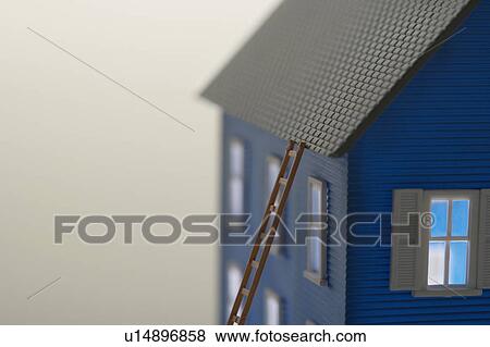 Stock Photo - Model of house with ladder, close-up. Fotosearch