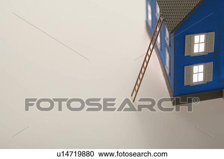 Stock Image - Model of house with ladder. Fotosearch