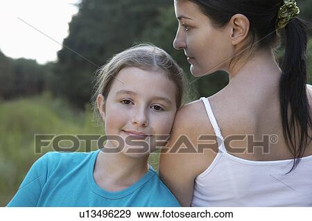 Mother and daughter in meadow, close-up View Large Photo Image Stock Photo - Mother and daughter in meadow, close-up. Fotosearch