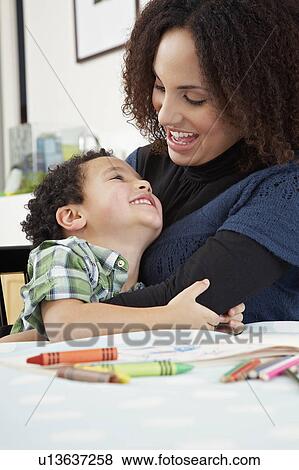 Mother and son (5-6) embracing and laughing View Large Photo Image Stock Photo - Mother and son (5-6) embracing and laughing. Fotosearch