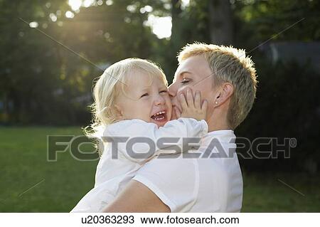Mother carrying daughter (3-4) in garden, girl crying View Large Photo Image Stock Image - Mother carrying daughter (3-4) in garden, girl crying. Fotosearch