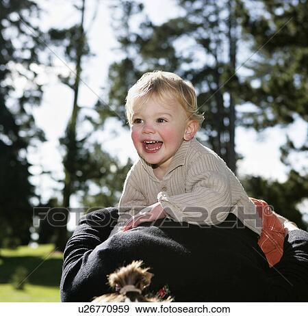 Mother carrying son (3-4) on back View Large Photo Image Stock Photo - Mother carrying son (3-4) on back. Fotosearch
