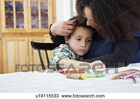 Stock Image - Mother consoling son (5-6). Fotosearch