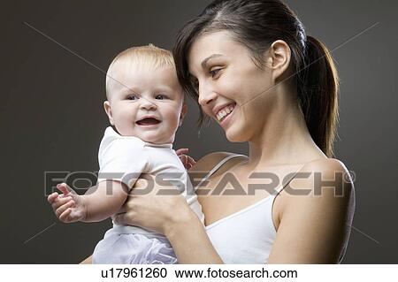 Mother embracing baby boy View Large Photo Image Stock Image - Mother embracing baby boy. Fotosearch