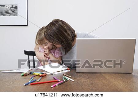 Mother sonsoling sad daughter (3-4), open laptop on table View Large Photo Image Stock Image - Mother sonsoling sad daughter (3-4), open laptop on table. Fotosearch