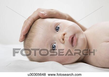 Mothers hand on baby boys head View Large Photo Image Stock Photo - Mothers hand on baby boys head. Fotosearch