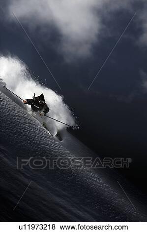 Stock Photo - Night skiier on Les Arcs in the French Alps. Fotosearch