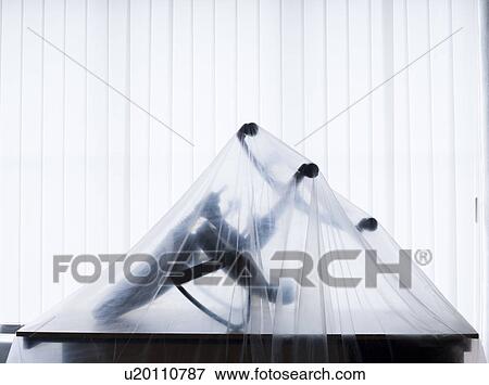 Stock Photo - Office chair under curtain. Fotosearch