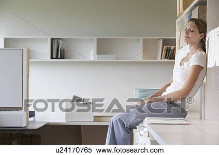 Office worker sitting on bench in office, side view View Large Photo Image Stock Photography - Office worker sitting on bench in office, side view. Fotosearch