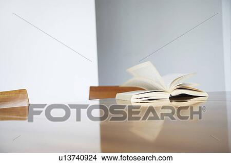 Picture - Open book on table, close-up. Fotosearch