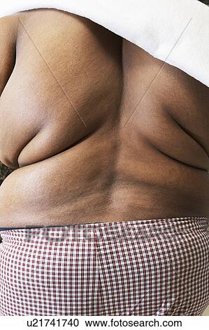Stock Image - Overweight man with bare back, rear view. Fotosearch