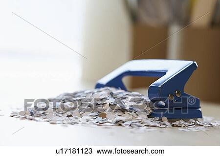 Stock Image - Paper Bits by Hole Punch. Fotosearch