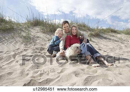 Parents with daughter (5-6) and dog on beach, portrait View Large Photo Image Stock Image - Parents with daughter (5-6) and dog on beach, portrait. Fotosearch