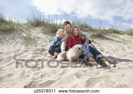 Parents with daughter (5-6) and dog on beach View Large Photo Image Stock Image - Parents with daughter (5-6) and dog on beach. Fotosearch