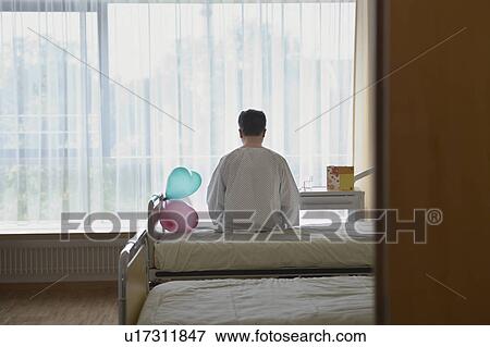 Patient Sitting on Hospital Bed by balloons, back view View Large Photo Image Stock Photo - Patient Sitting on Hospital Bed by balloons, back view. Fotosearch