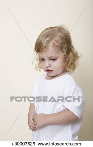 Pensive child in white t-shirt View Large Photo Image Stock Photography - Pensive child in white t-shirt. Fotosearch