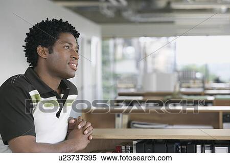 Stock Photography - Pensive man sitting in office. Fotosearch