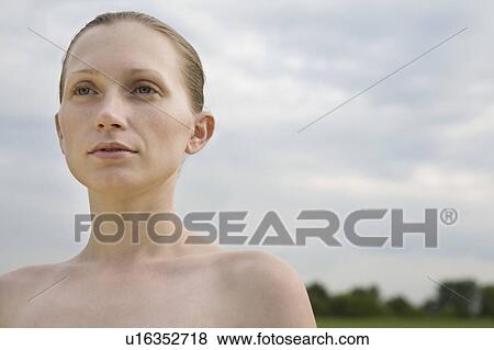 Pensive young woman in field View Large Photo Image Stock Photo - Pensive young woman in field. Fotosearch