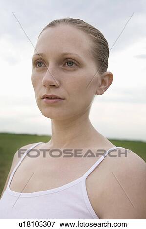 Pensive young woman in field View Large Photo Image Stock Photo - Pensive young woman in field. Fotosearch