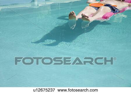 Person floating in pool View Large Photo Image Stock Photo - Person floating in pool. Fotosearch