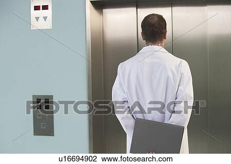Physician Waiting for the Elevator, back view View Large Photo Image Stock Image - Physician Waiting for the Elevator, back view. Fotosearch