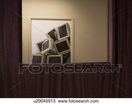 Stock Image - Pile of Old Monitors in Empty Office. Fotosearch