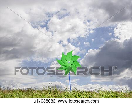 Stock Image - Pinwheel against cloudy sky. Fotosearch
