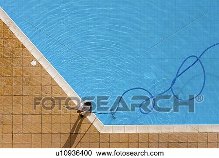 Pool cleaner works with coiled hosepipe View Large Photo Image Stock Image - Pool cleaner works with coiled hosepipe. Fotosearch