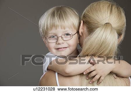 Stock Photo - Portrait Of Boy Held By His Mother, Studio Shot. Fotosearch