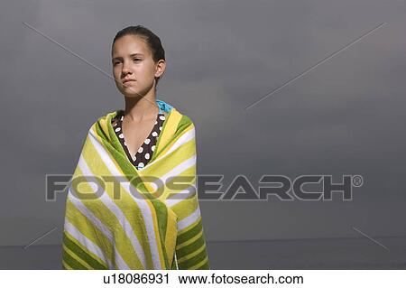 Stock Image - Portrait of girl wrapped in towel. Fotosearch