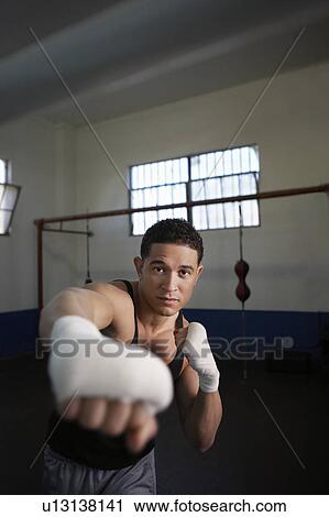 Stock Image - Portrait of man training in gym. Fotosearch
